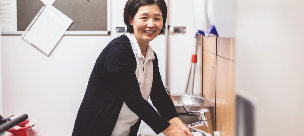 Lady washing hands in sink