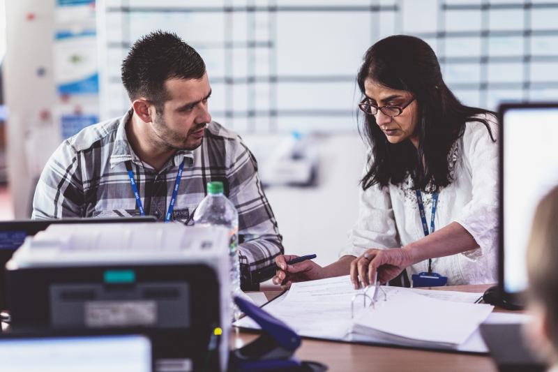 A meeting between two healthcare professionals in plan clothes