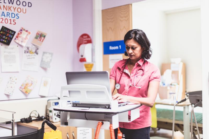 A medical staf member with a trolley.