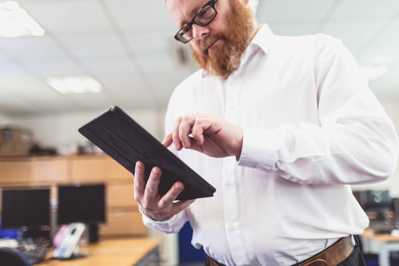 Member of staff using an electronic tablet