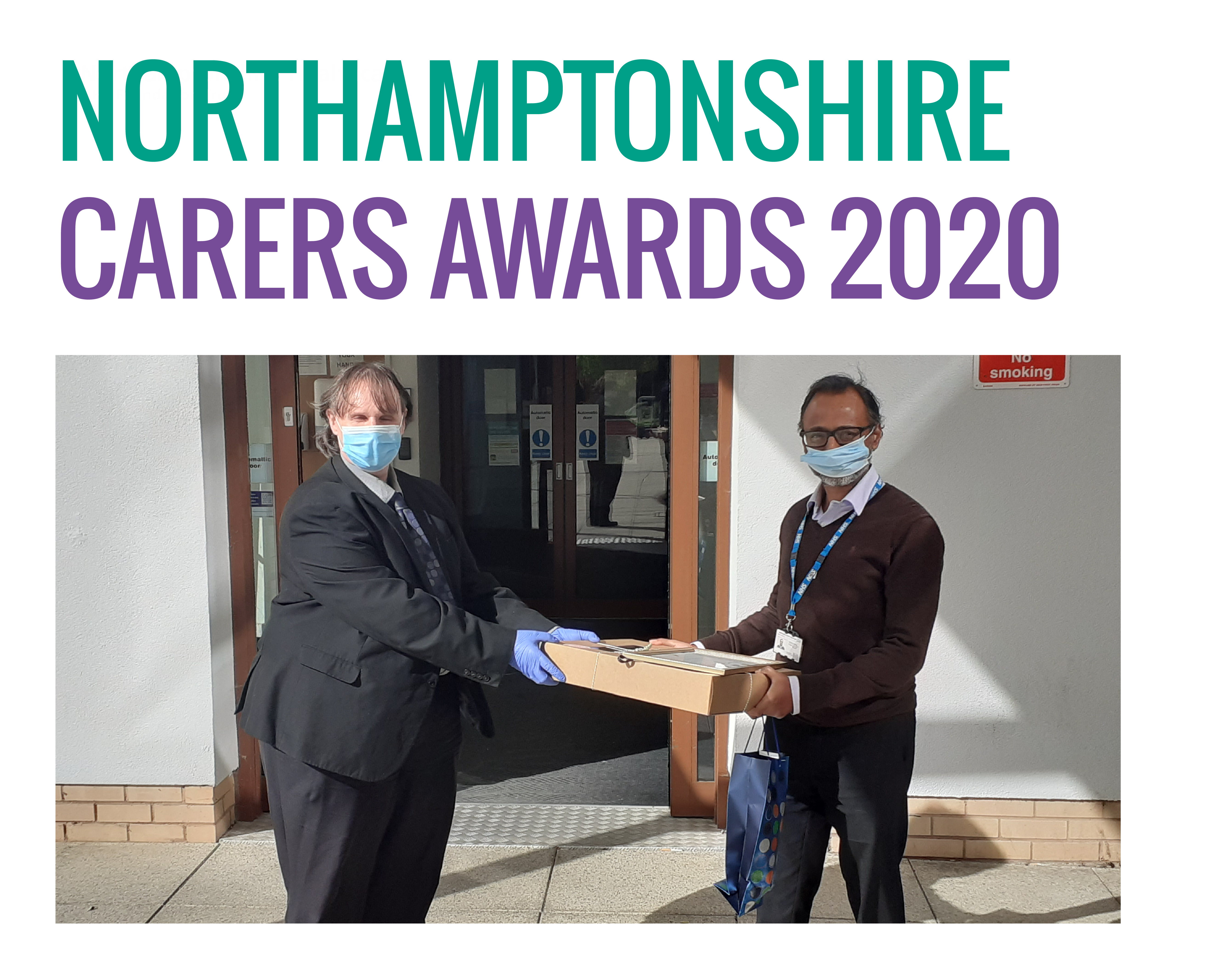 Gwyn Roberts and Dr Krishna Yathiraj at the Entrance of Berrywood Hospital wearing face masks handing over the prize