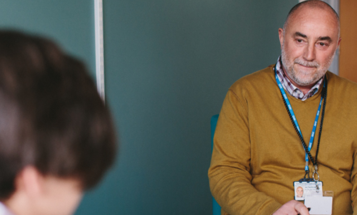 Male colleague in an office with young person service user