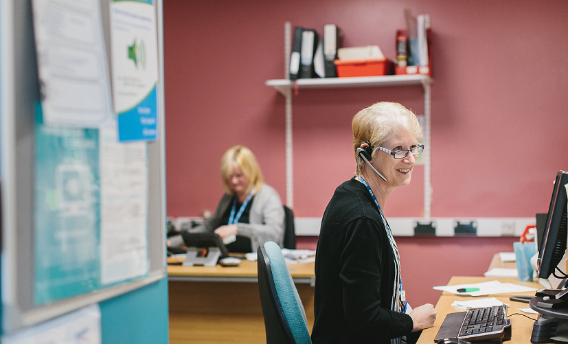 Female colleague speaking on the phone in office