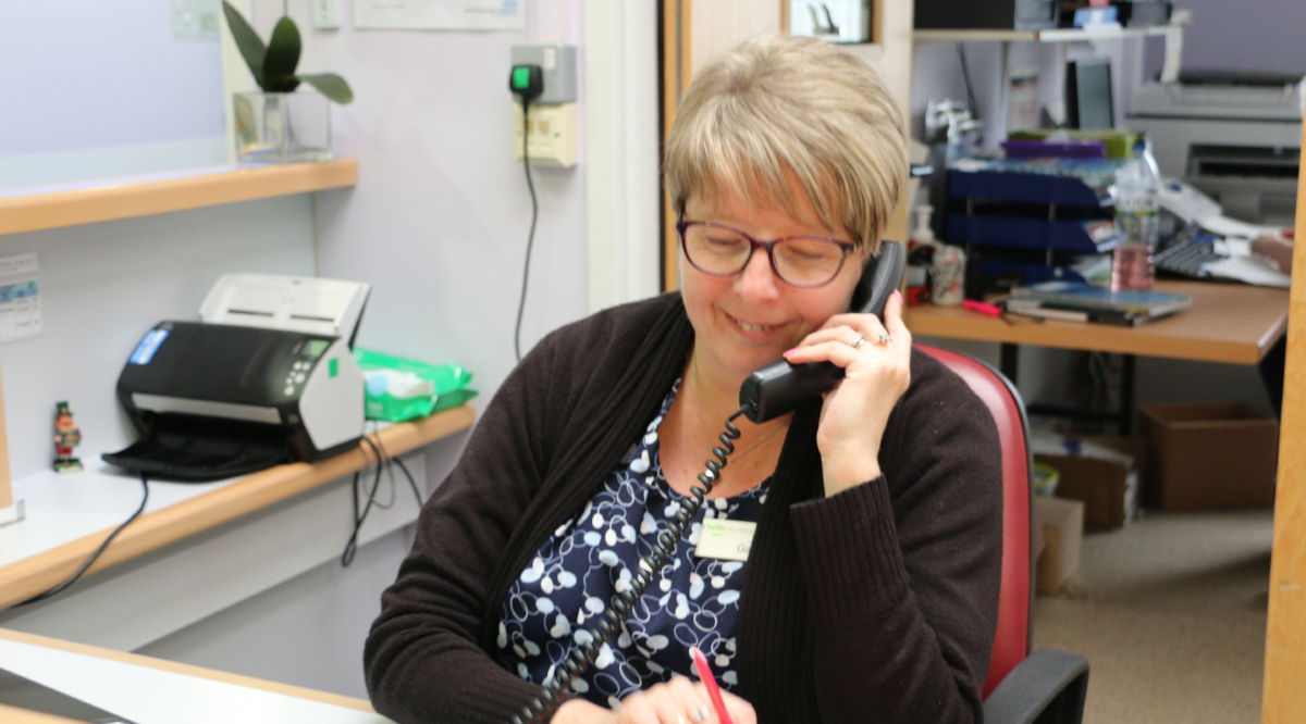 Female on the phone in an office smiling