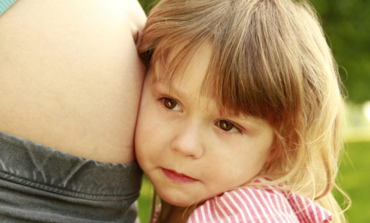 Women with pregnancy bump and small child 