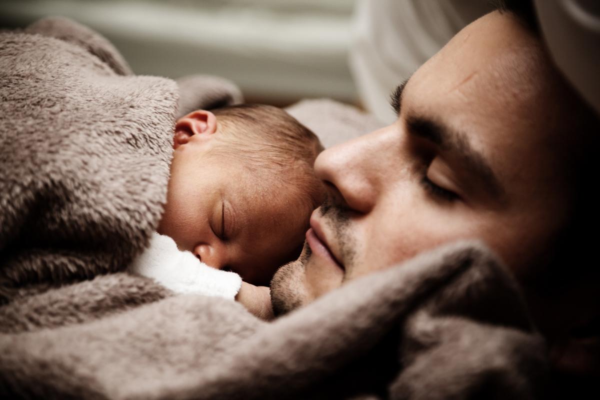 Man with baby on his chest