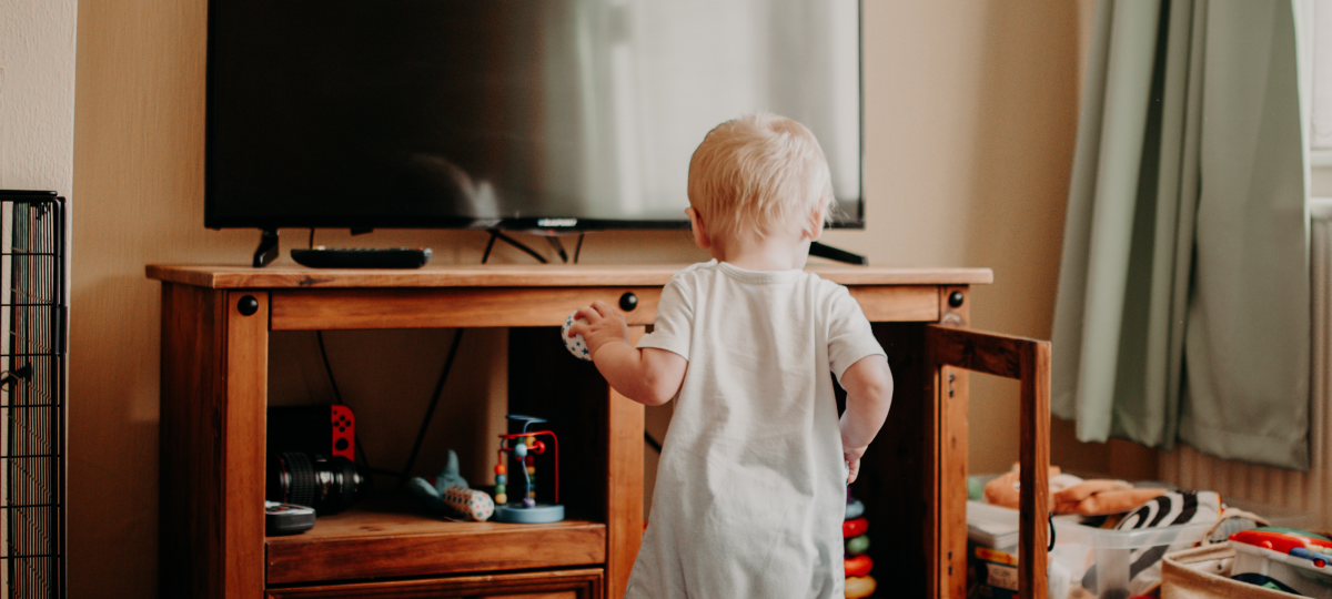 Toddler surrounded by toys