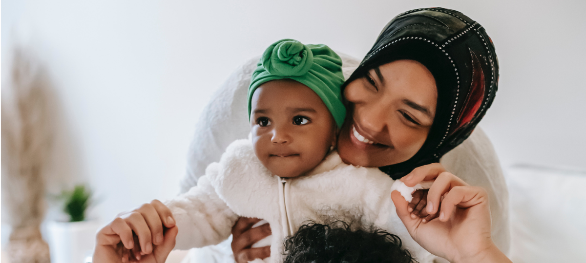 Baby and mum smiling at the camera