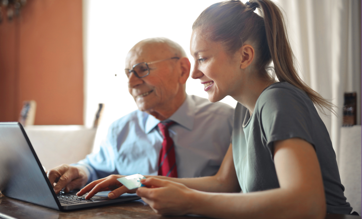 Man and woman looking at computer screen sat down