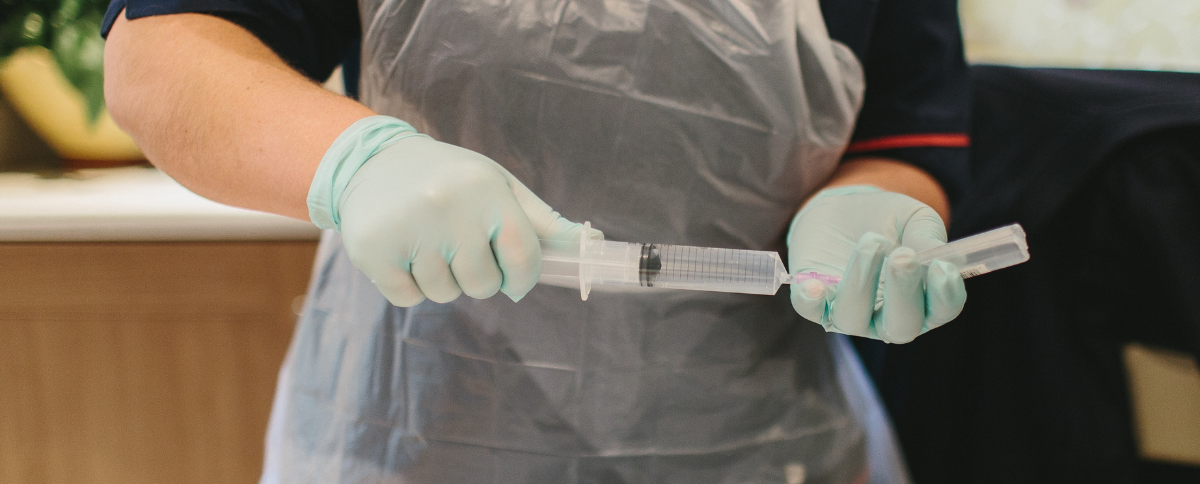 Female nurse filling up a syringe