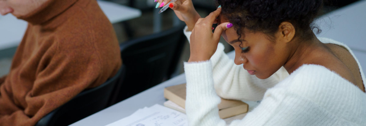 A teenager looks stressed as they take an examination