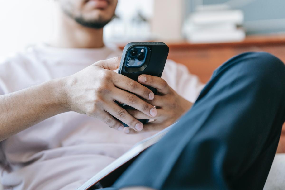 Stock image of male on mobile phone from pexles