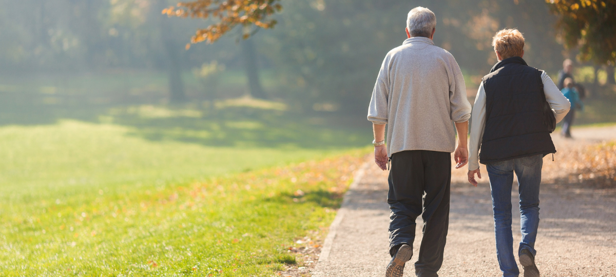 Older couple walking in a park