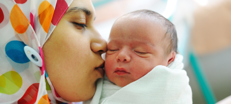 Mother kissing baby