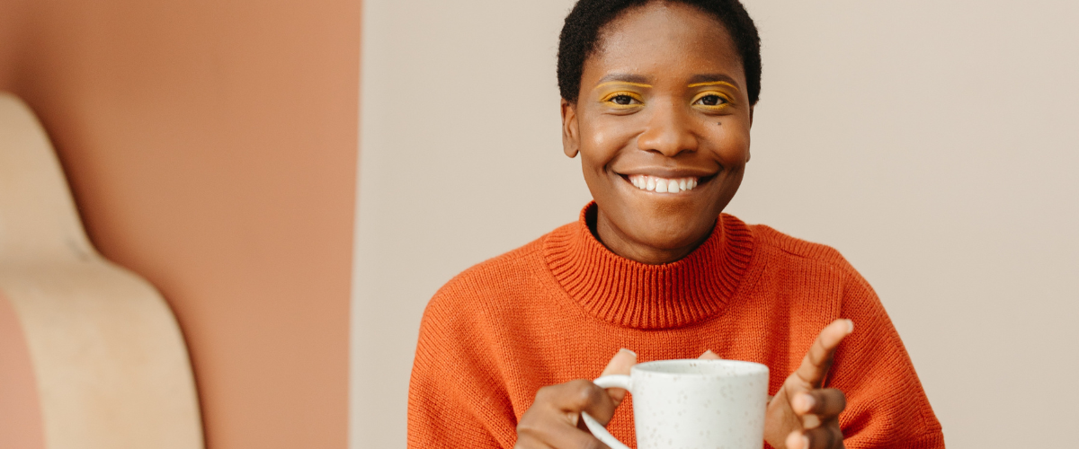 Woman starting at camera with cup of tea