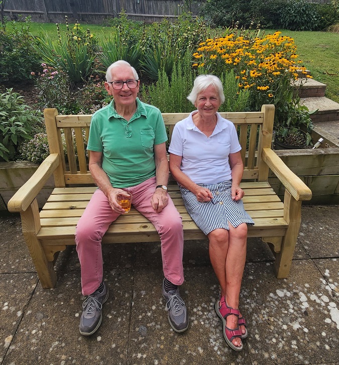 Retiring gardeners John and Sue on bench at The Martins