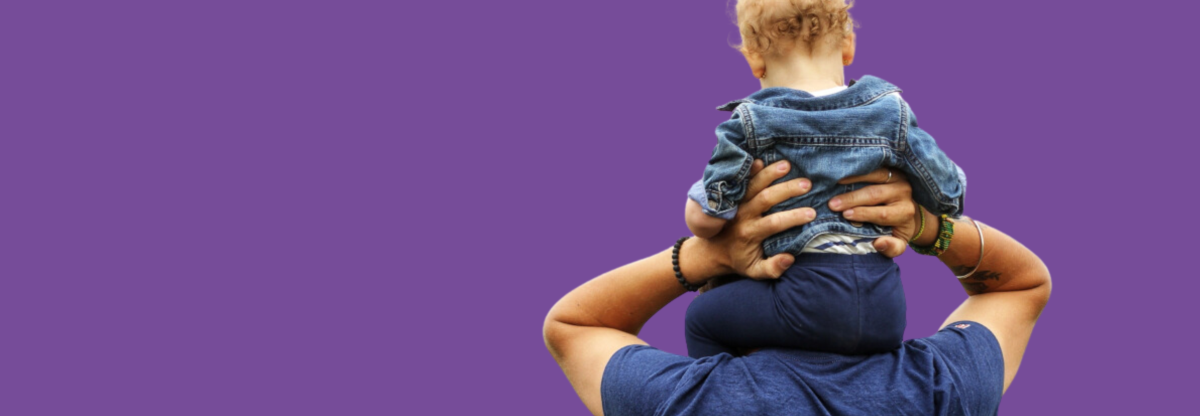 A close-up photography of a man holding an infant on his shoulders viewed from behind outdoors
