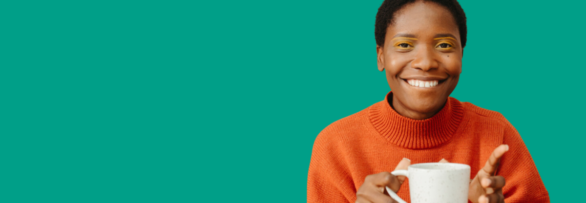 A cutout image of a woman smiling while holding a mug against a green background