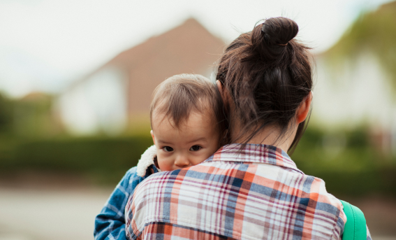 Mother holding baby, baby face to camera