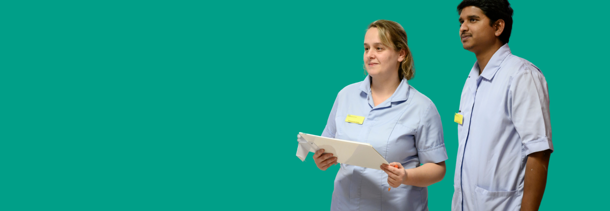 A male and a female healthcare assistant looking off to the left against a green background
