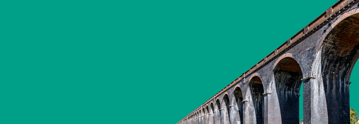 A cutout image of a viaduct against a green background