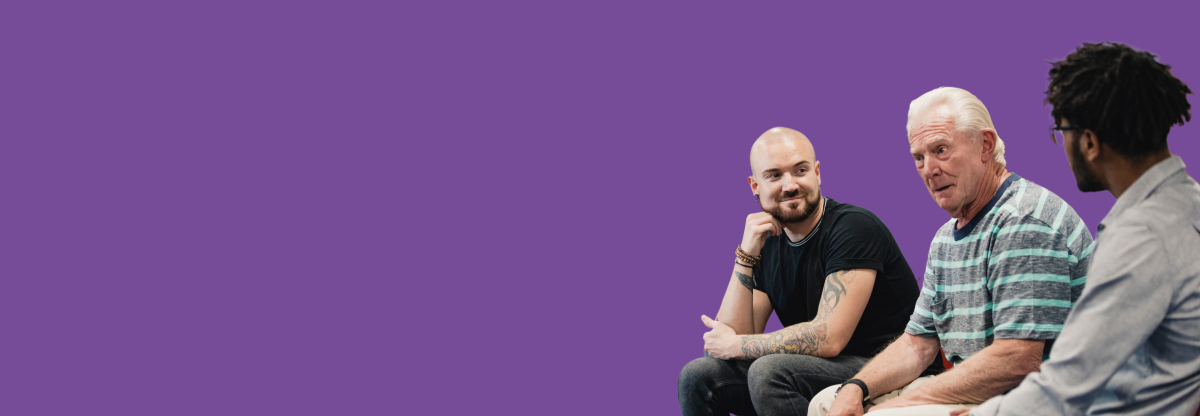 A cutout image of three men seated in a group therapy session against a purple background