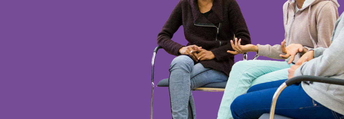 A cutout image of three unidentified people having a group discussion against a purple background