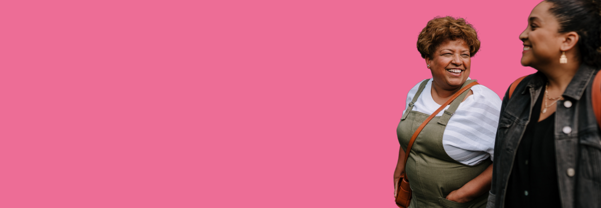 A cutout image of two women walking outdoors and smiling against a pink background