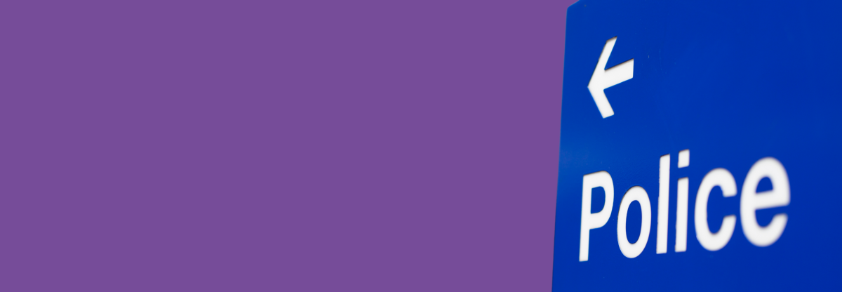 A cutout image of a police sign with an arrow against a purple background