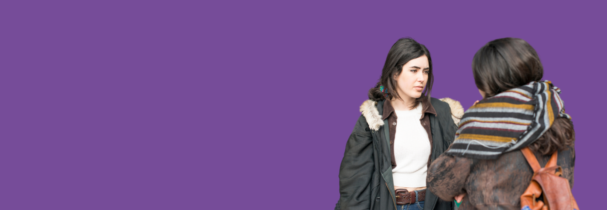 A cutout image of two young women talking outside against a purple background